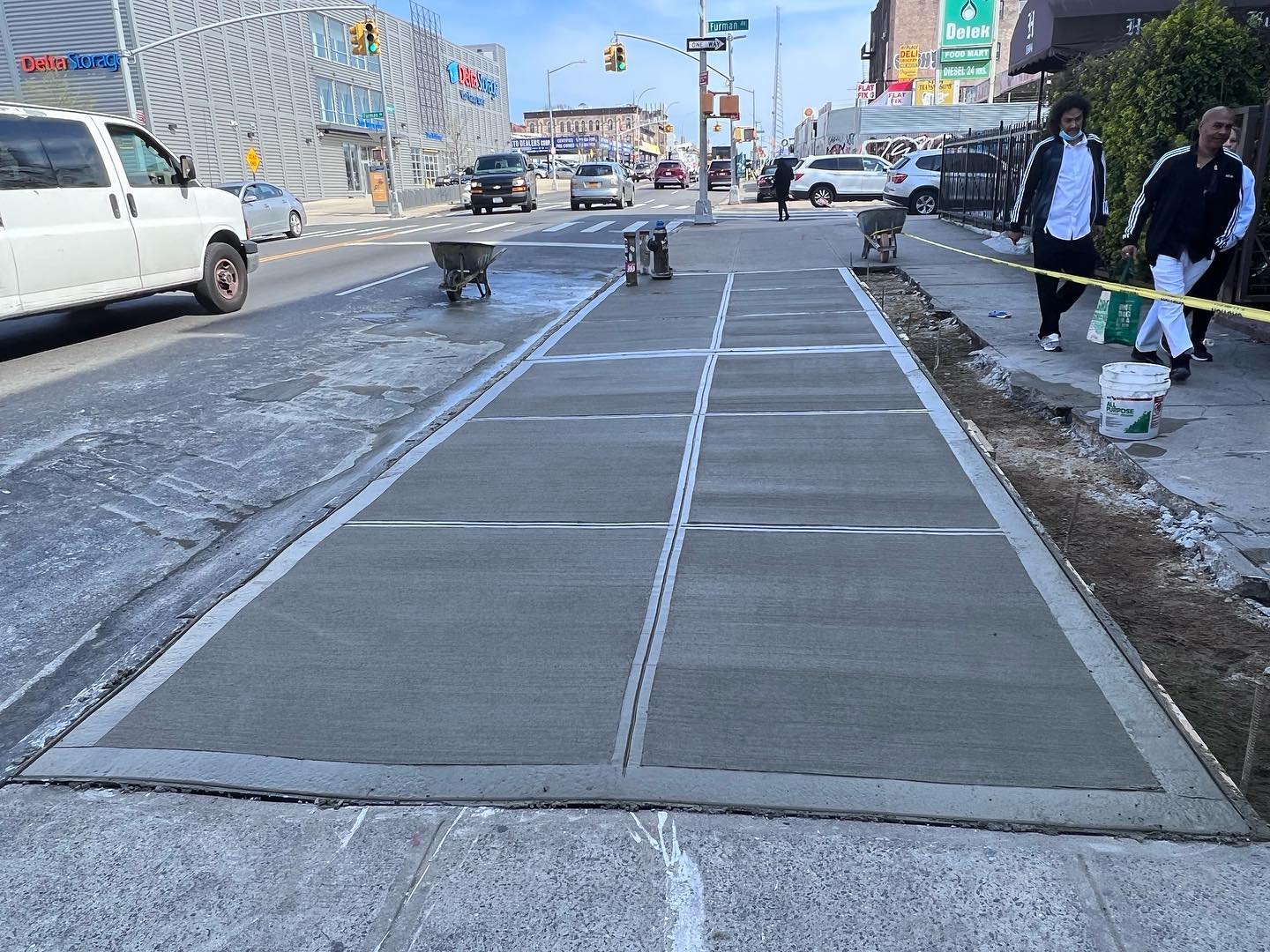 Pouring new concrete sidewalk at queens